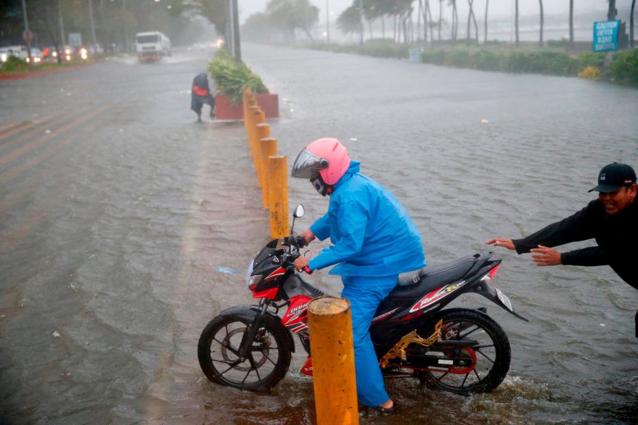 A motorist tries to avoid the flooding in Manila on September 15.