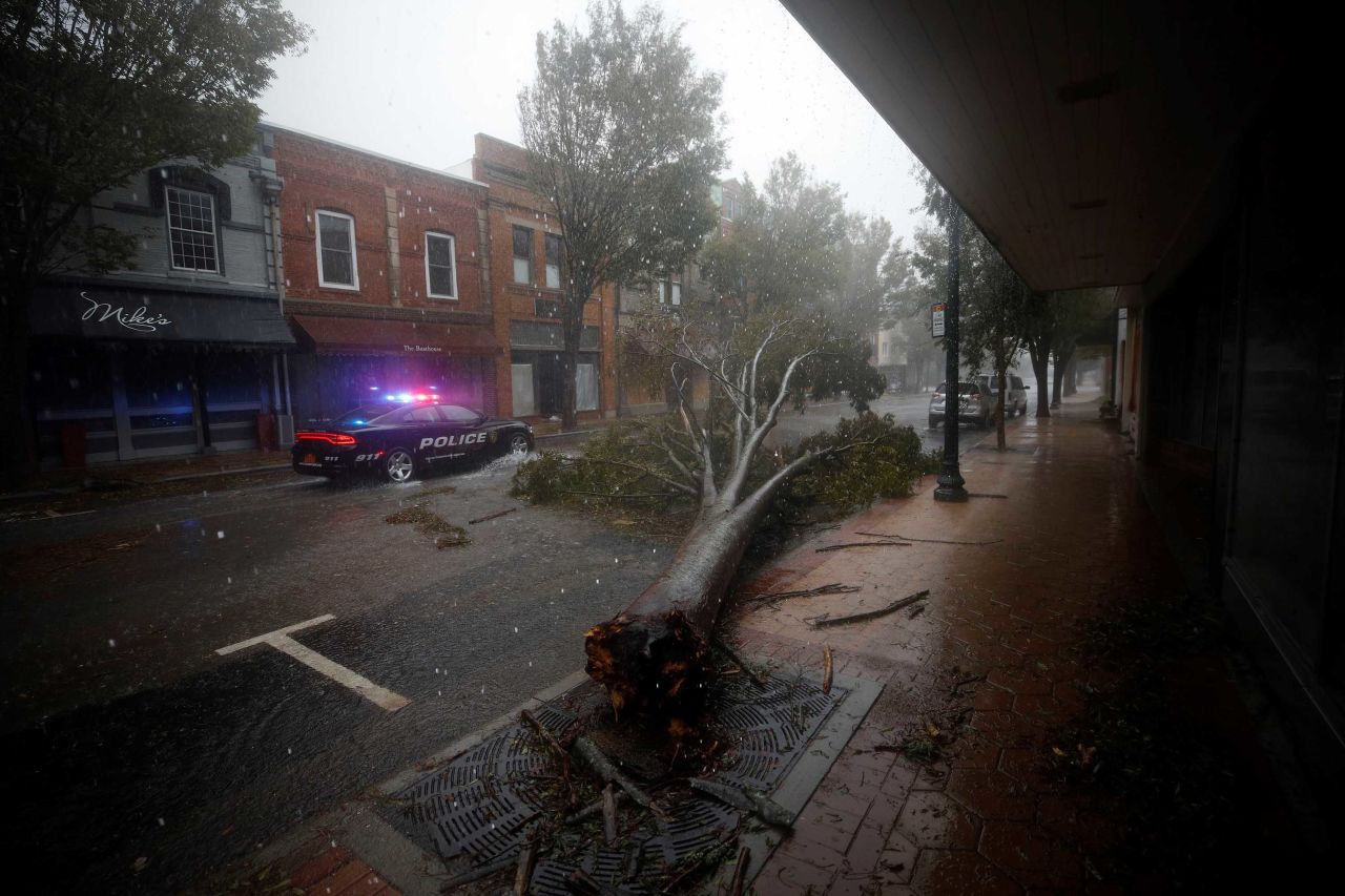 The storm leaves a tree toppled in New Bern on September 14.