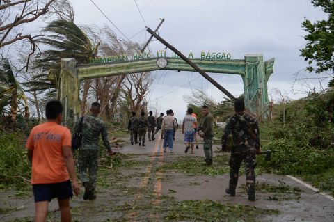 Crews work to clear a road of debris in Baggao on September 15.