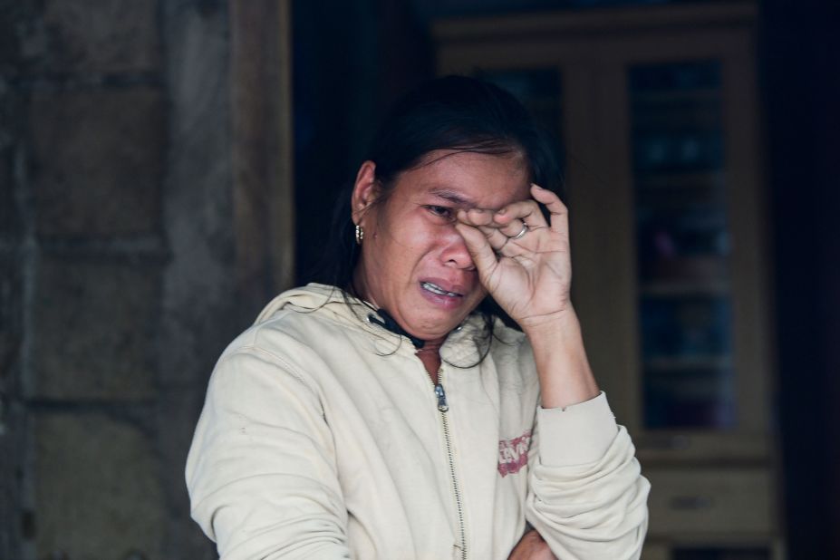 A woman weeps as she describes her family's experiences during the typhoon in Baggao on September 15.