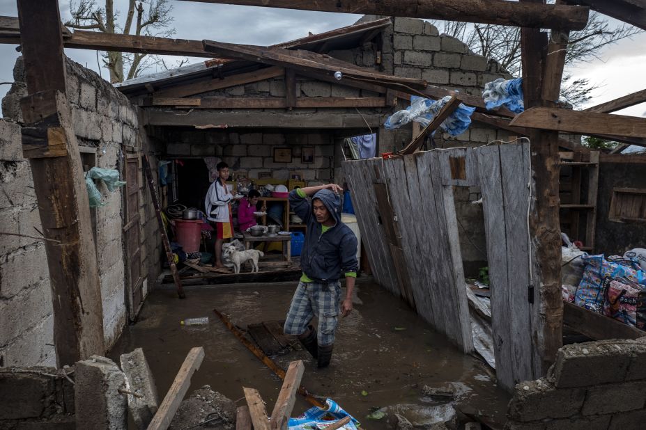 Members of a family survey their heavily damaged home in Alcala, Philippines, on September 15.