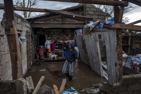 Members of a family survey their heavily damaged home in Alcala, Philippines, on September 15.