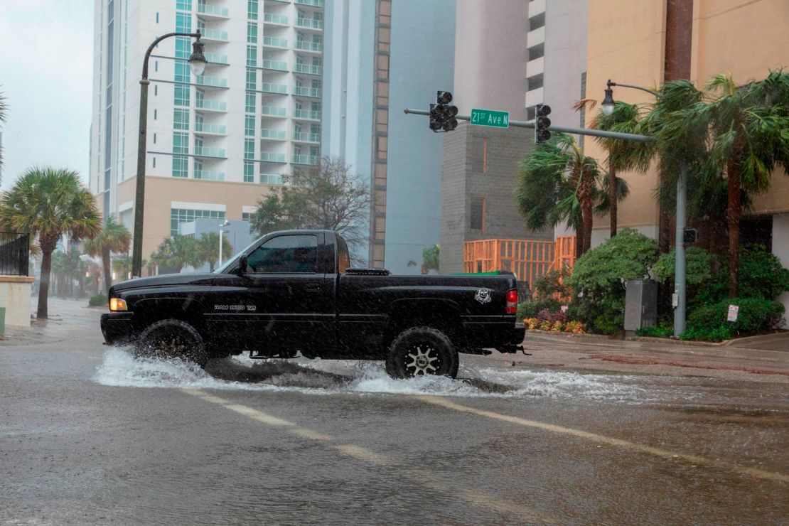 A car drives though rising floodwaters near the beach as Hurricane Florence makes landfall on Friday in Myrtle Beach, South Carolina.