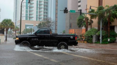 A car drives though rising floodwaters near the beach as Hurricane Florence makes landfall on Friday in Myrtle Beach, South Carolina.