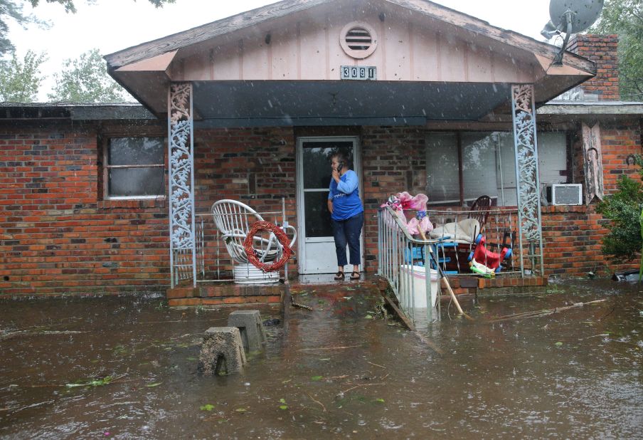 A woman calls for help at her flooded residence as Florence brought large amounts of rain and floodwaters to Lumberton, North Carolina, on Saturday.