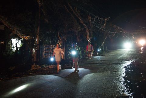 Volunteers and police check on residents after Typhoon Mangkhut hit Tuguegarao, Philippines, on Saturday.