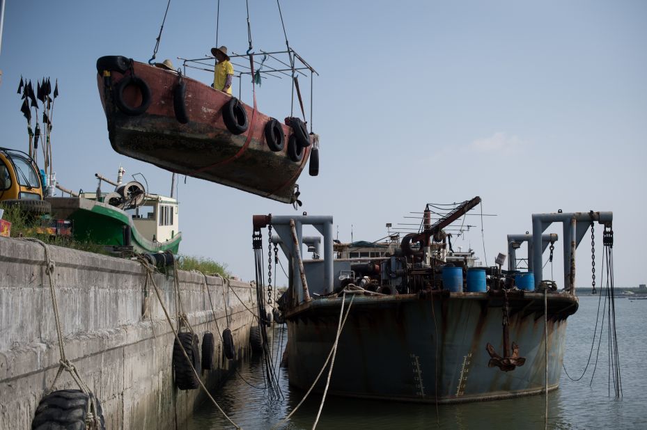 Fishermen remove their boat from the water ahead of the arrival of Typhoon Mangkhut on the outskirts of Zhanjiang, China, on Saturday.