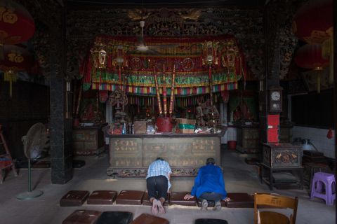 People pray inside of a temple ahead of the arrival of Typhoon Mangkhut in Sanhe village, China, on Saturday.