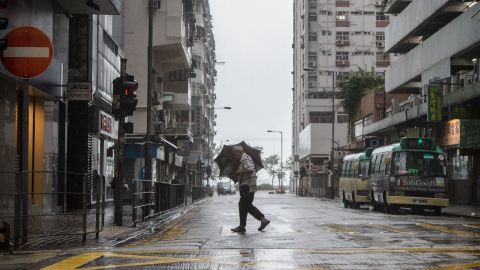 A man uses his umbrella while crossing a road as super Typhoon Mangkhut edges closer to Hong Kong on September 16, 2018.