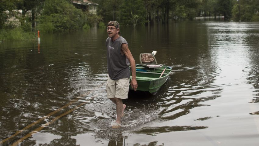 A man pulls his Jon Boat through a neighbourhood flooded from heavy rains after Hurricane Florence made landfall on September 14, 2018, in Vanceboro, North Carolina, on September 15, 2018. - The governor of North Carolina warned residents displaced by a killer storm against returning home because of the dangers posed by rising floodwaters. (Photo by Andrew CABALLERO-REYNOLDS / AFP)        (Photo credit should read ANDREW CABALLERO-REYNOLDS/AFP/Getty Images)