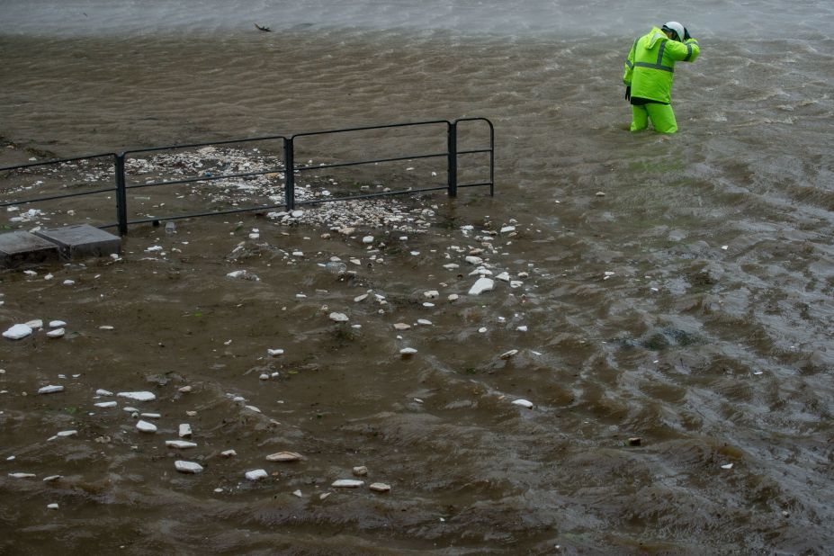 A security guard wades across floodwaters in Heng Fa Chuen on Sunday, September 16.