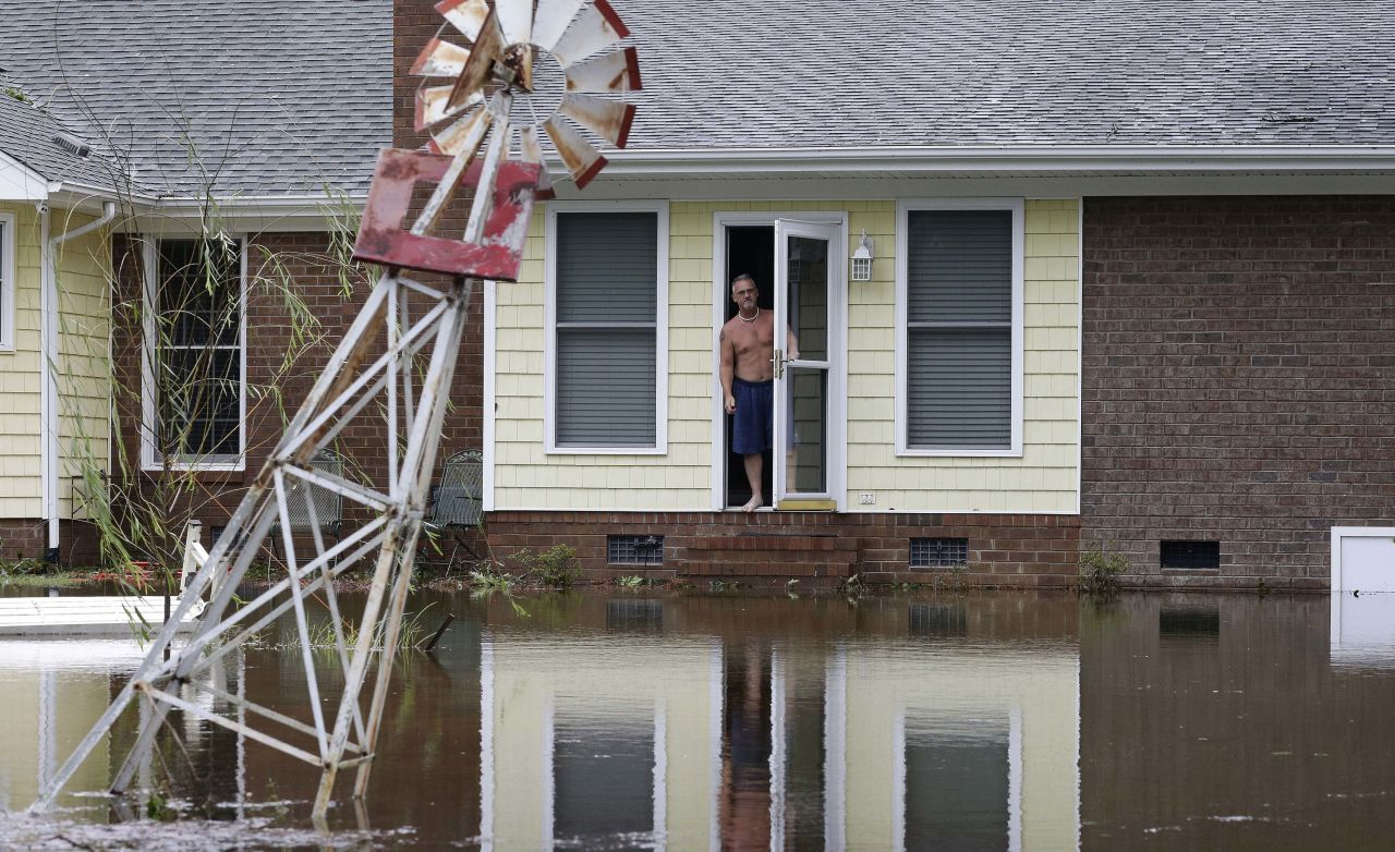 A man peers from his flooded home in Lumberton on September 16.