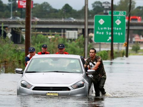 Members of the Coast Guard help a stranded motorist in floodwaters in Lumberton, North Carolina, on September 16.