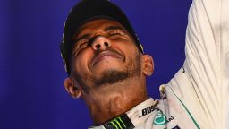 The joy of victory is plain to see as Lewis Hamilton celebrates on the podium after the Singapore Grand PRix.
