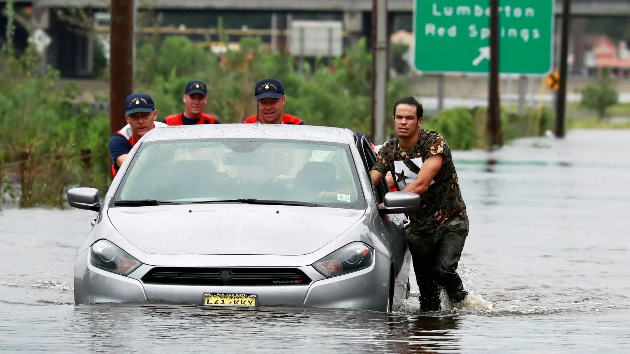 Coast Guard members help a stranded motorist Sunday in Lumberton, North Carolina.