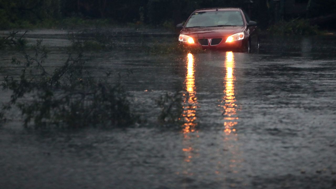 A car is stuck on a flooded street, on September 16, 2018 in Wilmington, North Carolina. Hurricane Florence hit Wilmington as a category 1 storm causing widespread damage and flooding across North Carolina.