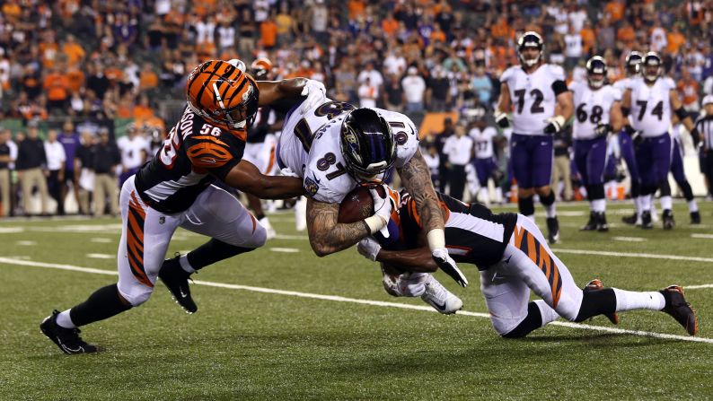 Baltimore Ravens tight end Maxx Williams is upended by Cincinnati Bengals linebacker Hardy Nickerson and defensive back Darqueze Dennard in the second half of the game at Paul Brown Stadium in Cincinnati, Ohio, on Thursday, September 13.