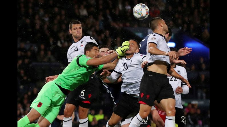 Albania's Thomas Strakosha, Berat Djimsiti and Rey Manaj fight for the ball during the match between Scotland and Albania in Glasgow, Scotland, on Monday, September 10.