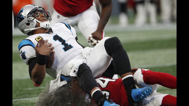 Carolina Panthers quarterback Cam Newton is sacked by Atlanta Falcons cornerback Brian Poole during the first half of the NFL game in Atlanta on Sunday, September 16.