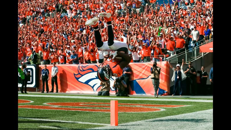 Denver Broncos wide receiver Emmanuel Sanders flips into the end zone after scoring a touchdown in the second quarter against the Seattle Seahawks at Broncos Stadium on Sunday, September 9.