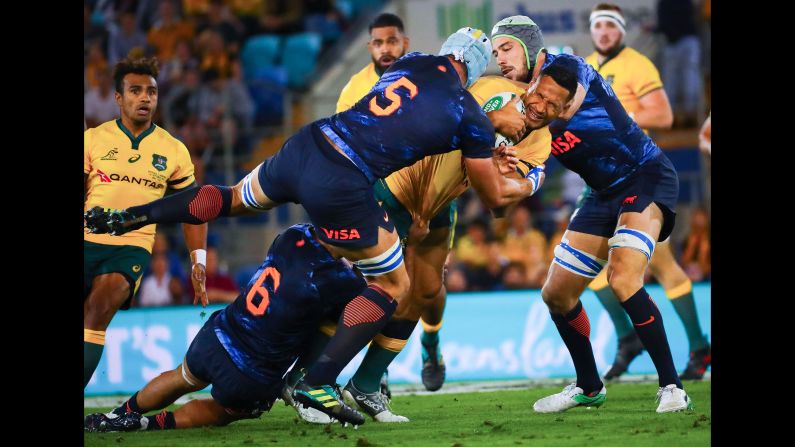 Australia's Israel Folau is tackled by Argentina's Pablo Matera, left, and Tomas Lavanini, right, during the Rugby Championship match between Australia and Argentina on Sunday, September 15.