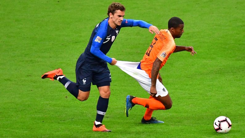 Antoine Griezmann of France receives a yellow card for a foul on Georginio Wijnaldum of Netherlands during the Nations League match between France and the Netherlands in Paris on Sunday, September 9.
