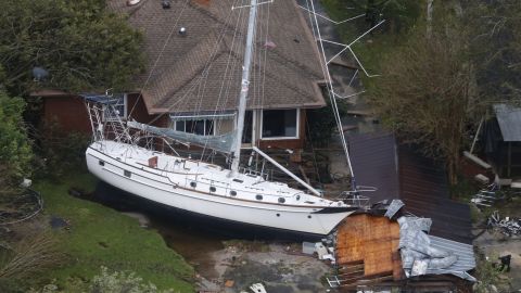 A sailboat is shoved up against a house and a collapsed garage Saturday, Sept. 15, 2018, after heavy wind and rain from Florence, now a tropical storm, blew through New Bern, N.C. (AP Photo/Steve Helber)