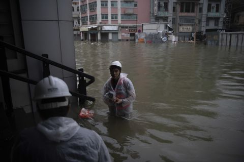 Rescuers evacuate areas in Macau.