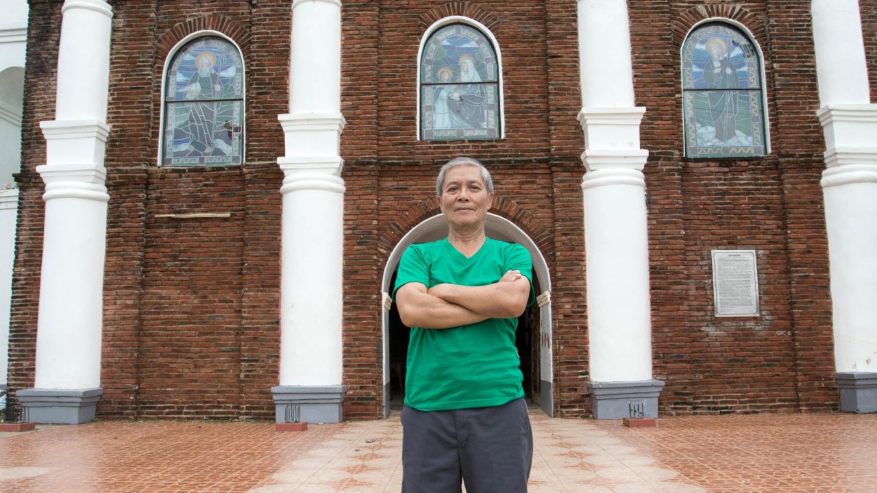 Arthur Pagador, 68, stands in front of Buguey's church.