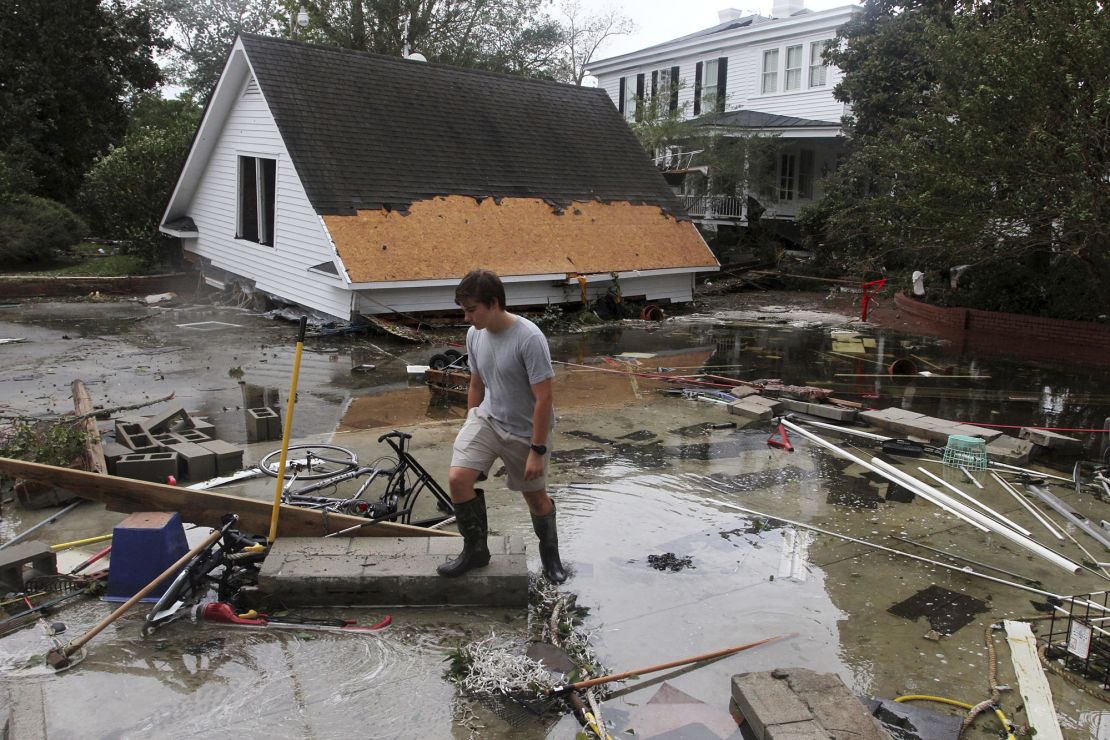 Resident Joseph Eudi looks at flood debris and storm damage from Hurricane Florence at a home on East Front Street in New Bern, North Carolina.