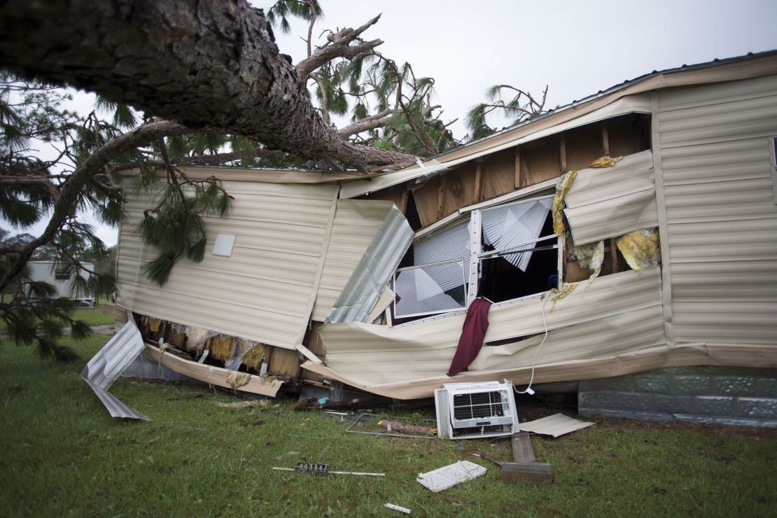 A large tree that fell during Hurricane Florence lies on top of a home in the Evergreen mobile home park in Newport, North Carolina.