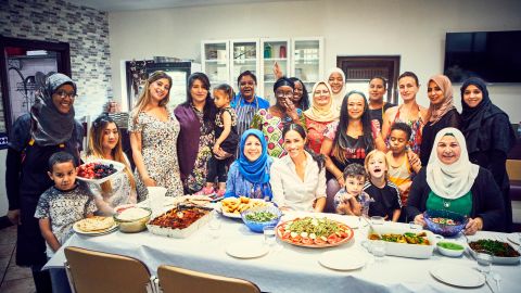 The Duchess of Sussex sits down for a meal with women at the Al Manaar Muslim Cultural Heritage Centre.