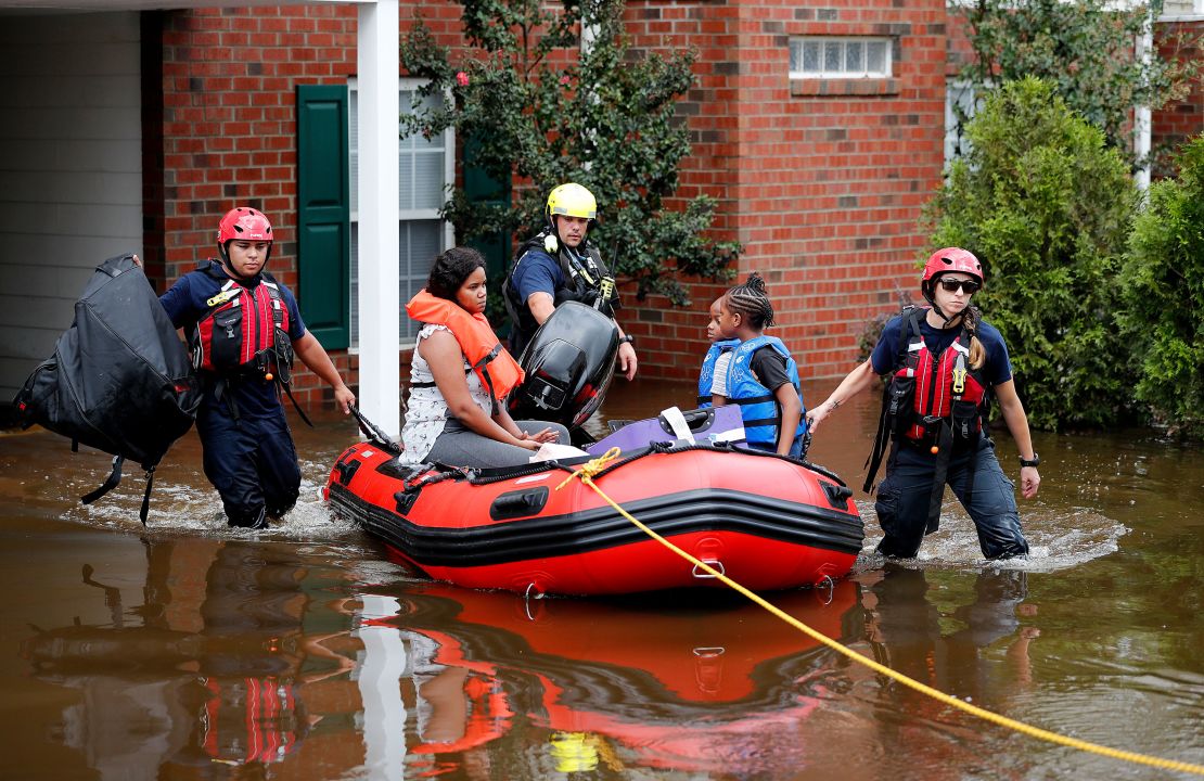 Rescue personnel evacuate residents as flooding in the aftermath of Hurricane Florence in Spring Lake, North Carolina.