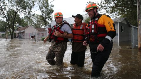 Lumberton Fire and Rescue members help a resident through floodwaters on Monday.