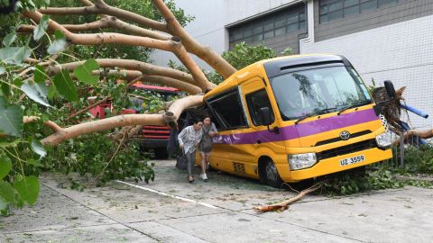 A school bus in Hong Kong's Heng Fa Chuen is left crushed by a tree during Typhoon Mangkhut.