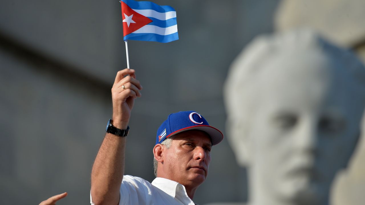 Cuban President Miguel Diaz-Canel waves a national flag during the May Day rally at Revolution Square in Havana.