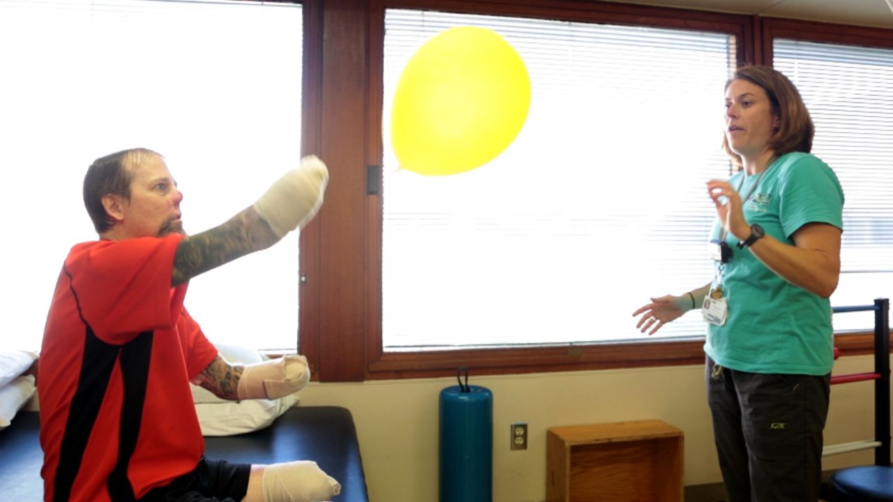 Physical therapist Cheryl Vorwald helps Greg Manteufel with his rehabilitation at Froedtert Hospital.