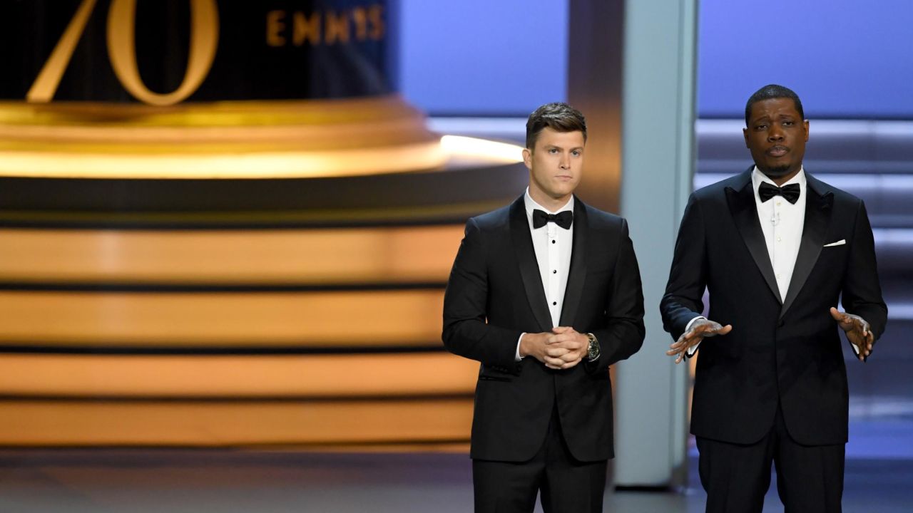 Colin Jost  and Michael Che speak onstage during the 70th Emmy Awards