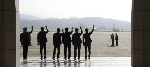 Seoul Military Air Base staff members wave as the South Korean President departs for Pyongyang on September 18.
