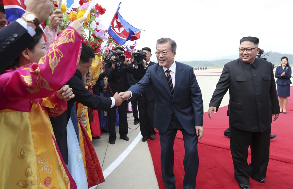 North Koreans welcome Moon at the airport in Pyongyang on September 18.