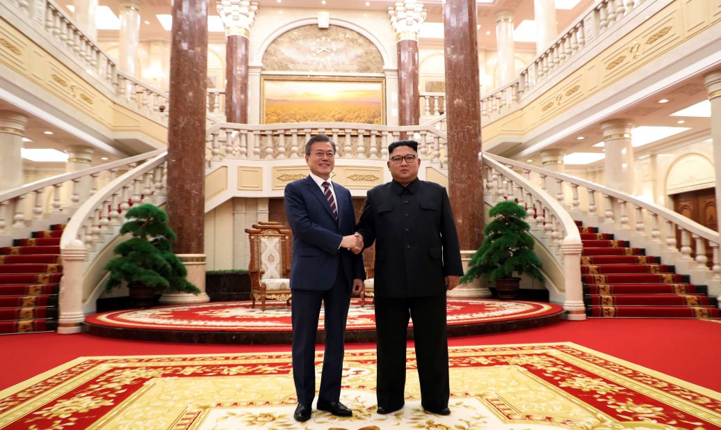 The two leaders greet each other before their summit at the headquarters of the Central Committee of the Workers' Party in Pyongyang on September 18.