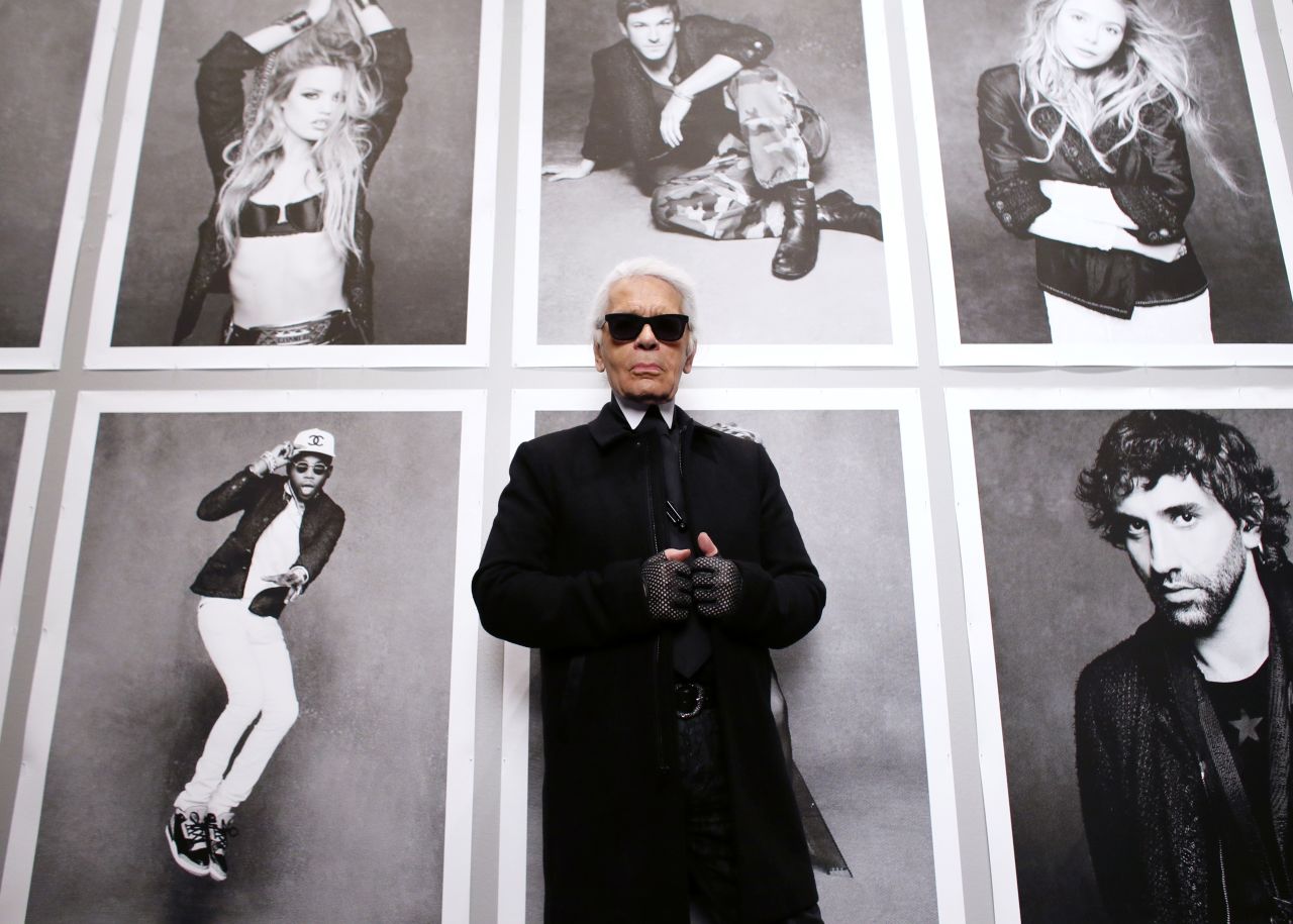 Lagerfeld poses at the opening of his "Little Black Jacket" exhibition at the Grand Palais in Paris in 2012.