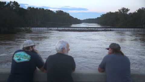 People look out at the Cape Fear river on Tuesday near Fayetteville, North Carolina.