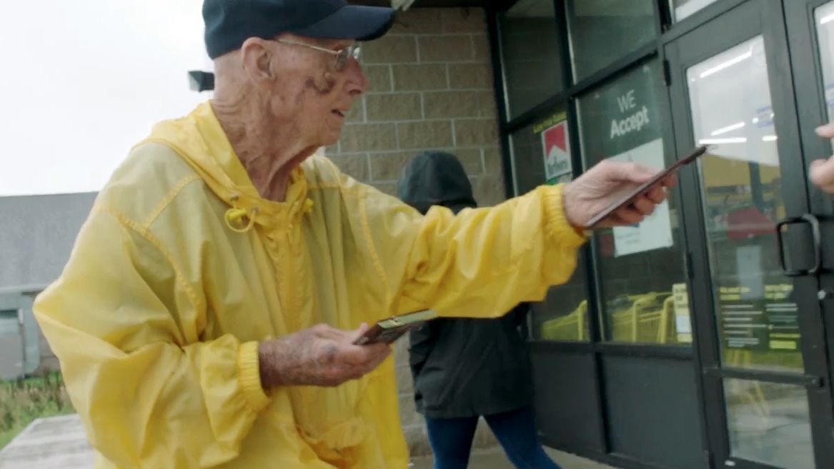 Bob Williams hands out Hershey's bars outside a Dollar General store near his home.
