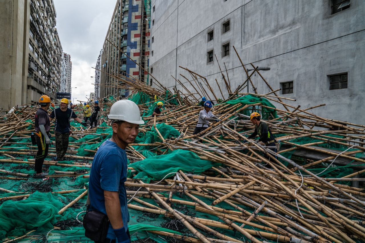 Workers in Hong Kong clean up scaffolding that had been knocked down by the storm.