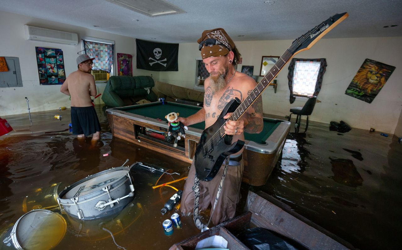 Ronnie Gainey pulls an electric guitar from his flooded home in Darlington, South Carolina.