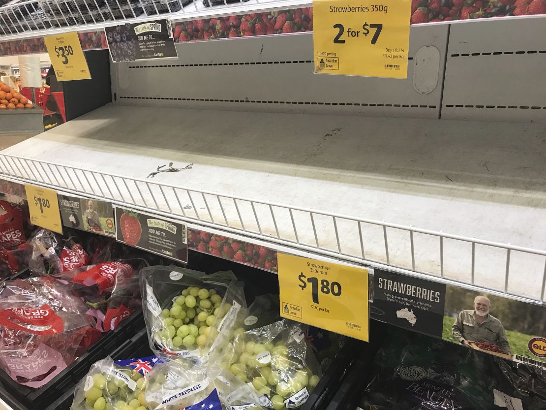 Empty shelves, normally stocked with strawberry punnets, are seen at a Coles Supermarket in Brisbane on September 14.