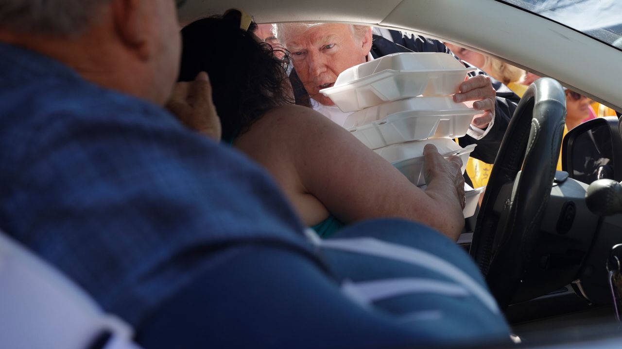 President Donald Trump hands out food at Temple Baptist Church, where food and other supplies were being distributed Wednesday, September 19, as part of Hurricane Florence recovery efforts in New Bern, North Carolina.