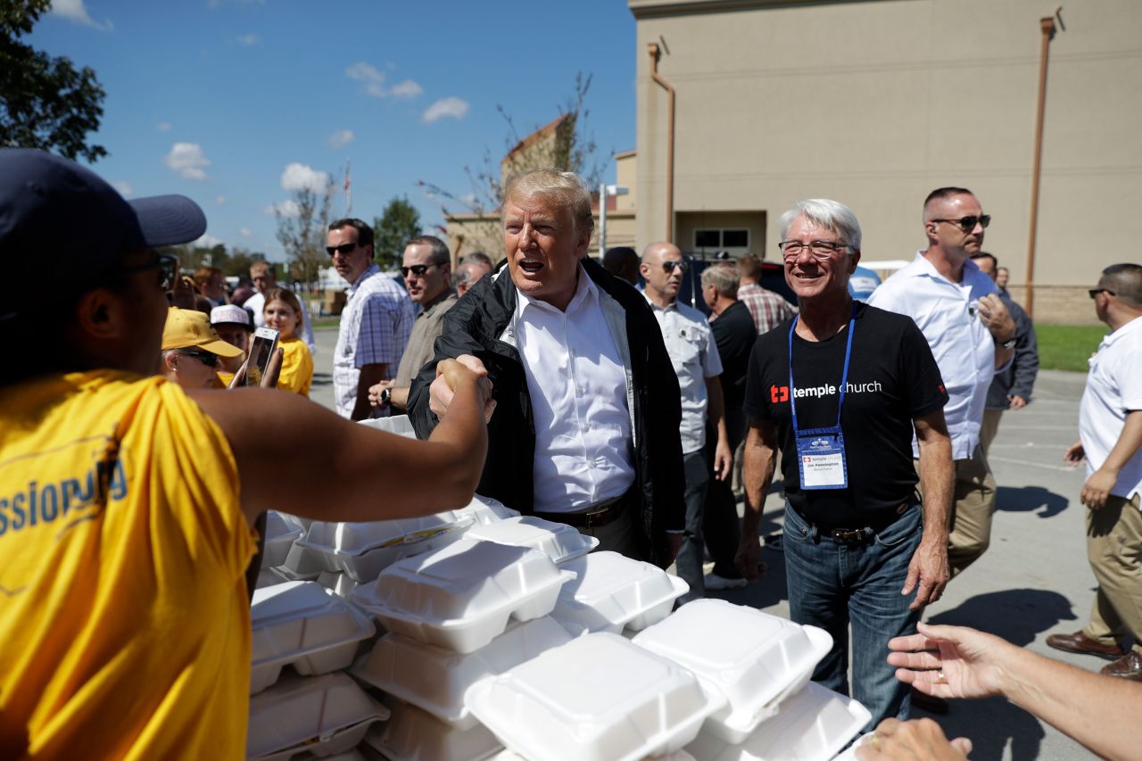Trump shakes hands as he visits the New Bern church on Wednesday.