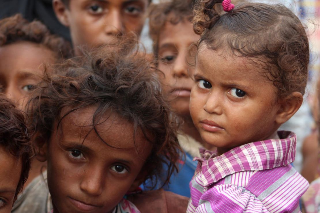 Displaced Yemeni children look on in a camp set up for people who fled the battle areas east of the port city of Hodeidah.